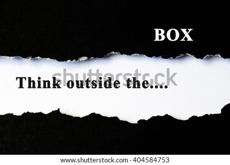 Think outside the box concept phrase under torn paper