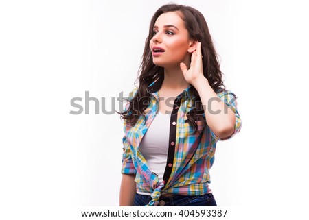 Beautiful woman puts a hand to the ear to hear better isolated on a white background