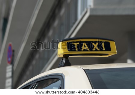 TAXI waiting on a street in Berlin in front of a shopping center