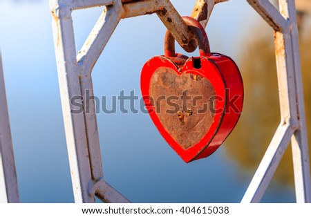 inspiring spring morning. Old padlock - the heart. attached to the fence by the lake. in a city park. concept of love. toned