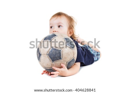 Baby boy playing with a soccer ball. Isolated on white background