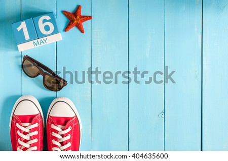 May 16th. Image of may 16 wooden color calendar on blue background.  Spring day, empty space for text.  Biographers Day