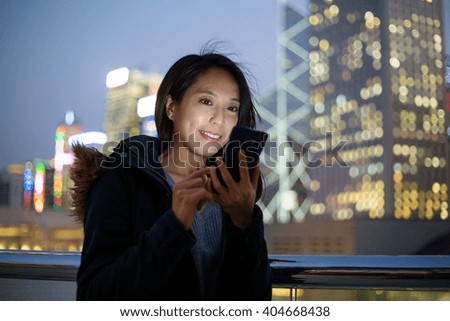 Woman using cellphone at night