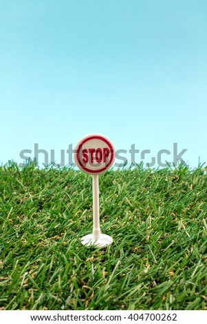 Stop Toy Sign on Green Grass.