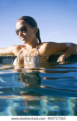 Young woman relaxing in a swimming pool
