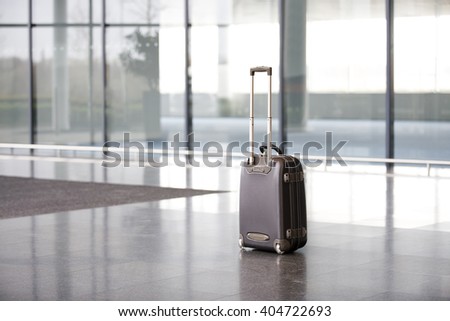 An unattended suitcase in office lobby Royalty-Free Stock Photo #404722693