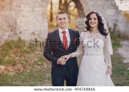 beautiful wedding couple celebrating their wedding day in autumn