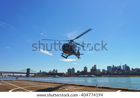 Helicopter and Brooklyn bridge and Manhattan bridge over East River on the background. Bridges connect Lower Manhattan with Brooklyn of New York, USA. Brooklyn Heights on the background.