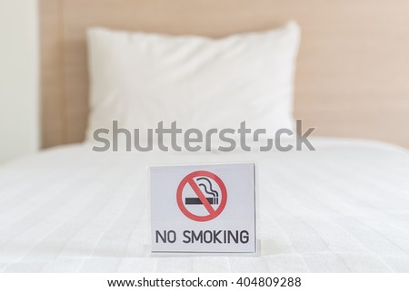 Close up NO SMOKING Sign on the bed in hotel room