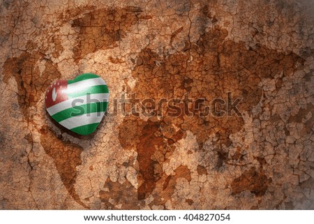 heart with national flag of abkhazia on a vintage world map crack paper background. concept