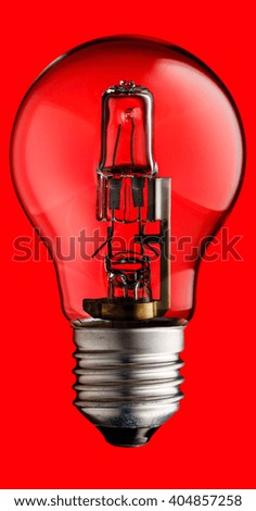 Realistic photo image of a halogen light bulb isolated on a red background and with a clipping path