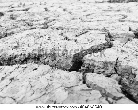 Climate change, the ground is dry, drought, cracked ground. Land with dry and cracked ground. black and white picture style.