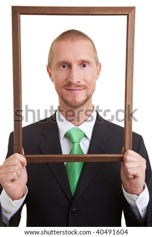 Manger holding empty frame in front of face