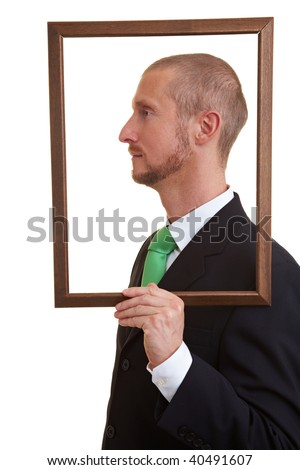 Manger holding empty frame beside his face