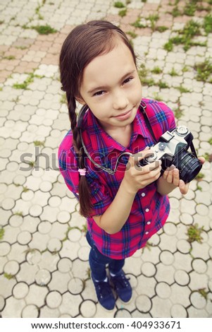 teenage girl with a camera. old photo camera. youth vintage lifestyle