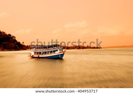 Ferry Boat on Wave in Sea and Sky Before Sunset