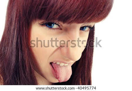 Grimasing face of teen brunette girl isolated on white (crossprocessed colors). Girl with tongue out wide angle shot.