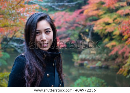 Happy Asian Girl in a park, Woman portrait in a park in Autumn Season