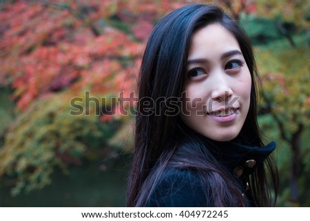 Happy Asian Girl in a park, Woman portrait in a park in Autumn Season