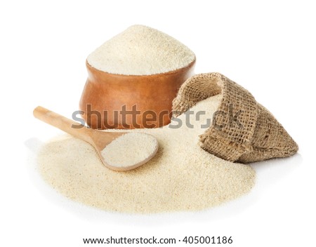 Raw unprepared semolina in bowl and spoon close-up isolated on white background Royalty-Free Stock Photo #405001186