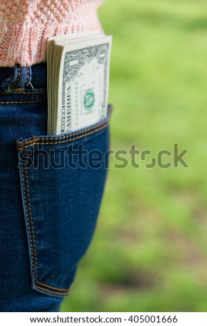  Money in women pocket in the park