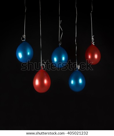 Red and blue balloons isolated in dark background, studio light, selective focus, birthday decoration, valentine's day,decor, balloon with shiny reflections, carnival