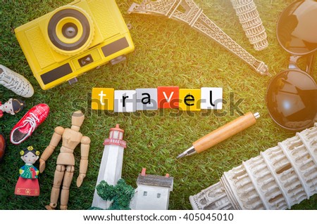 travel concept with souvenirs around the world on green grass view from top.jpg