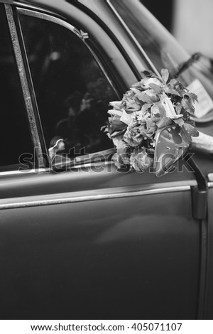 Bridal bouquet of various flowers on vintage silver car, pictur