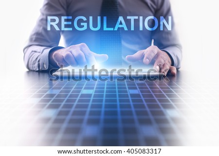 Businessman using tablet pc and select Regulation.