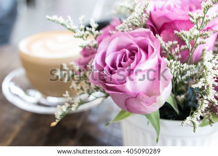 Roses with cup of coffee in the background ,soft focus ,blurred
