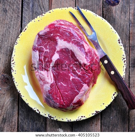 Raw beef steak on the wooden background