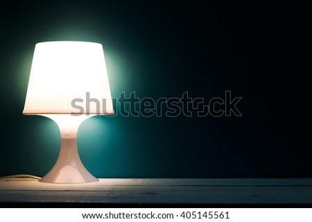 Lamp night light in a dark background. Vintage effect style picture. Minimal concept.