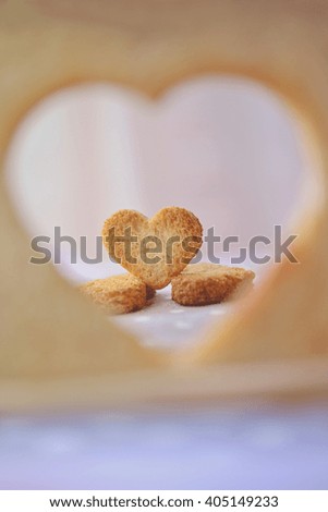 Breads cutting in shape of heart with love frame. Concept about love and relationship.