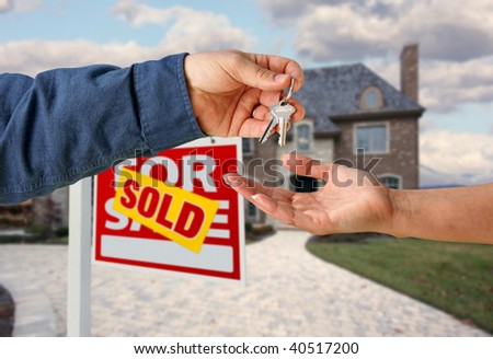 Handing Over the House Keys in Front of a Beautiful New Home.