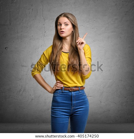 Woman showing her index finger with serious expression to make a warning sign