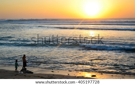 Fatfer with son on the beach in sunset