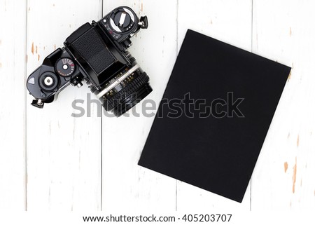Top view of old camera and book.