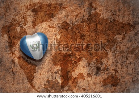 heart with national flag of guatemala on a vintage world map crack paper background. concept