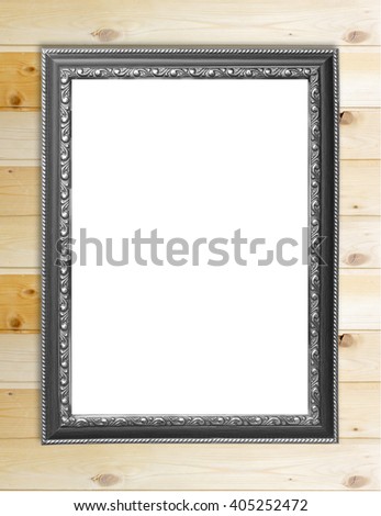 Empty picture frame on wooden wall.