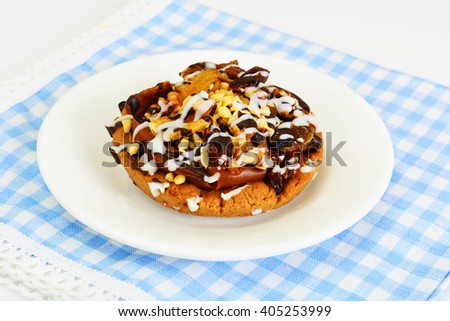 Homemade Cakes: Cake on Plate with Nuts, Chocolate and Raisins. Studio Photo