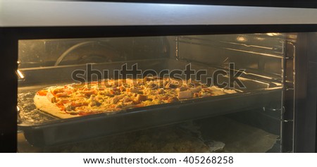 Freshly baked homemade pizza in the electric oven