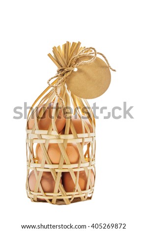 Closeup eggs in bamboo rattan packaging with paper blank tag. The image has clipping paths and you can cut the image from the background. 