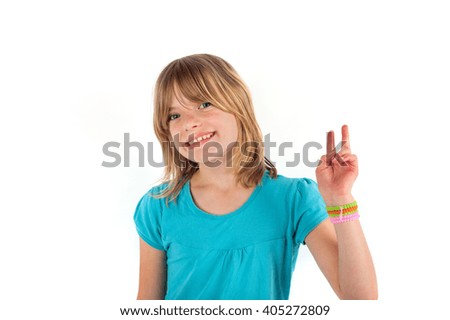cute young girl showing victory sign. Isolated on white background.