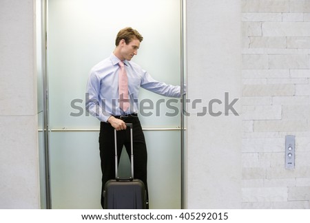 A businessman standing in a lift