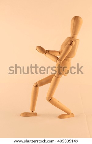 Wooden doll with joints in different positions suggestive actions, activities and characteristics of human attitudes.