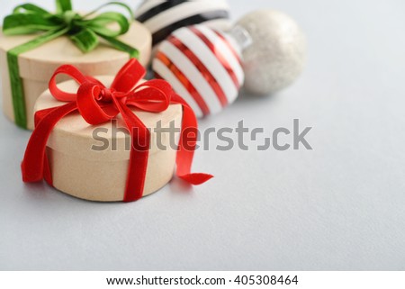 Round gift boxes with red and green ribbons on blue background