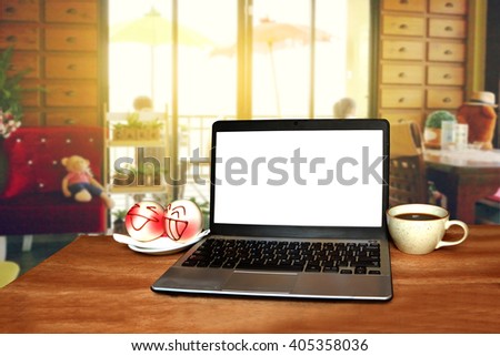laptop ,bread and coffee with blur image of people in coffee shop background