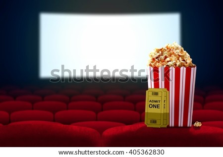 Cinema seat and pop corn facing empty movie screen Royalty-Free Stock Photo #405362830