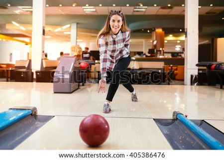 Beautiful woman enjoying  bowling