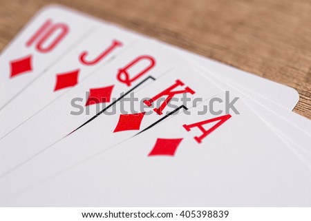 Set of Diamonds suit playing cards on wooden desk